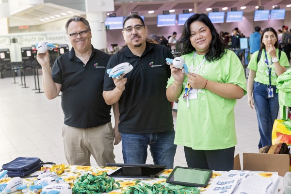 a group of people holding objects posing for the camera