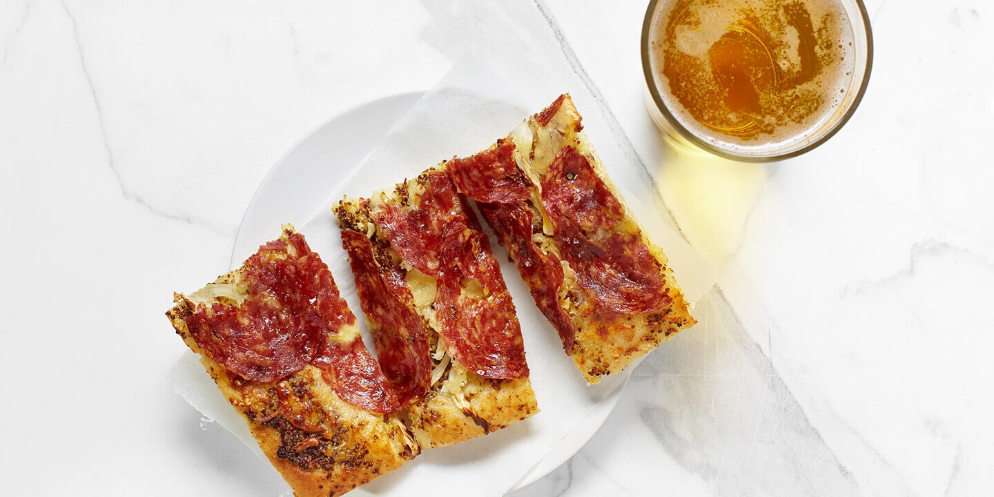 Focaccia with soprasetta and a glass of beer