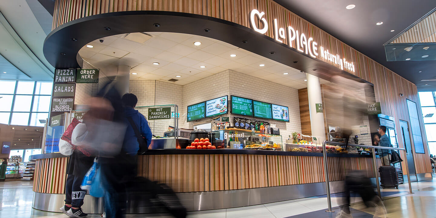 La Place location with fresh oranges on the counter and menu on the wall behind