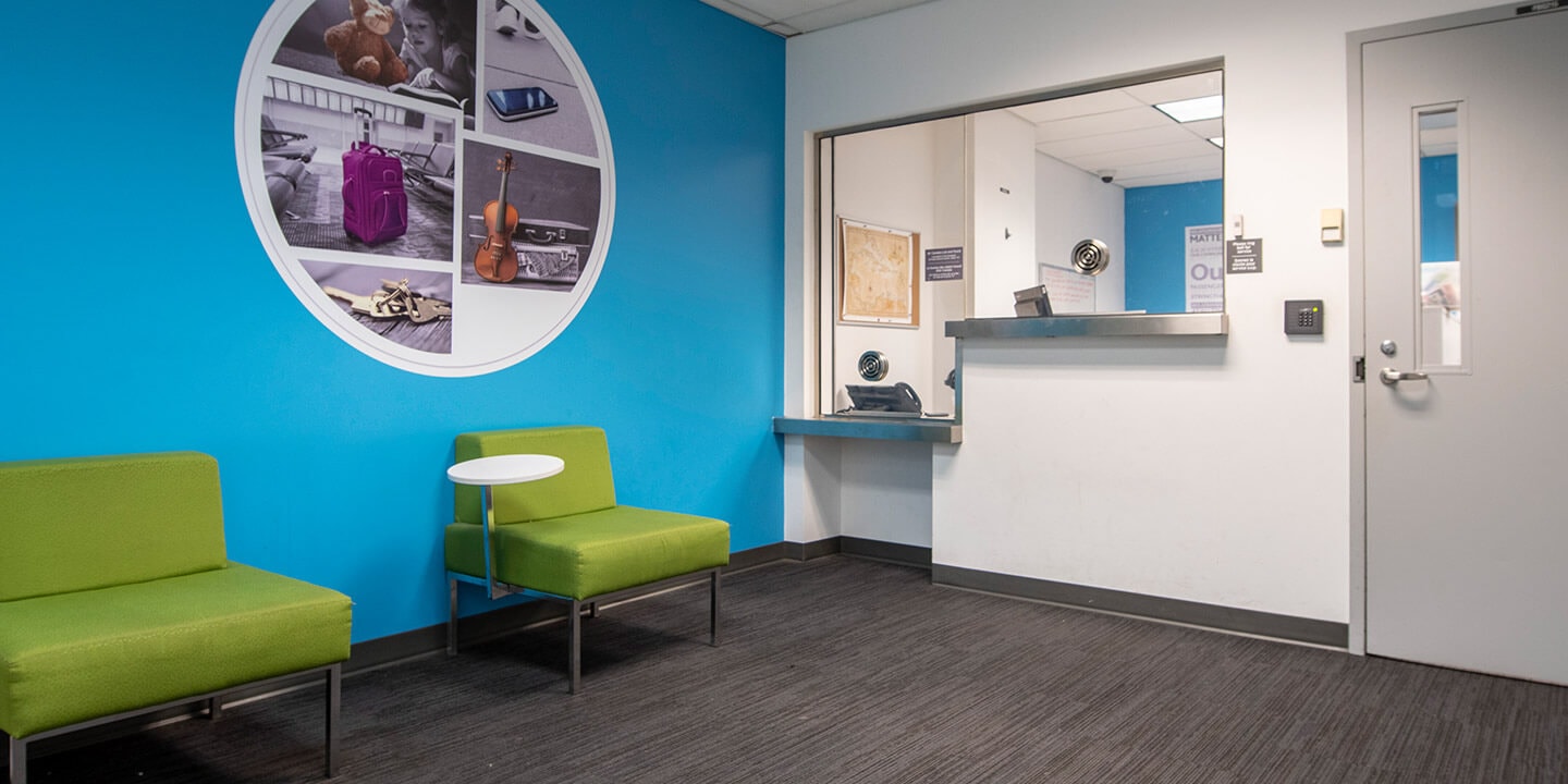 Lost and Found office with two chairs and high and low service counters.