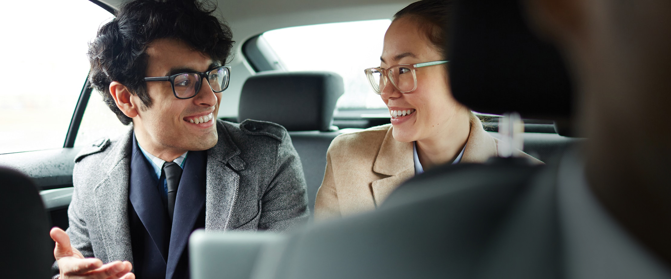 Two smiling people carpooling together