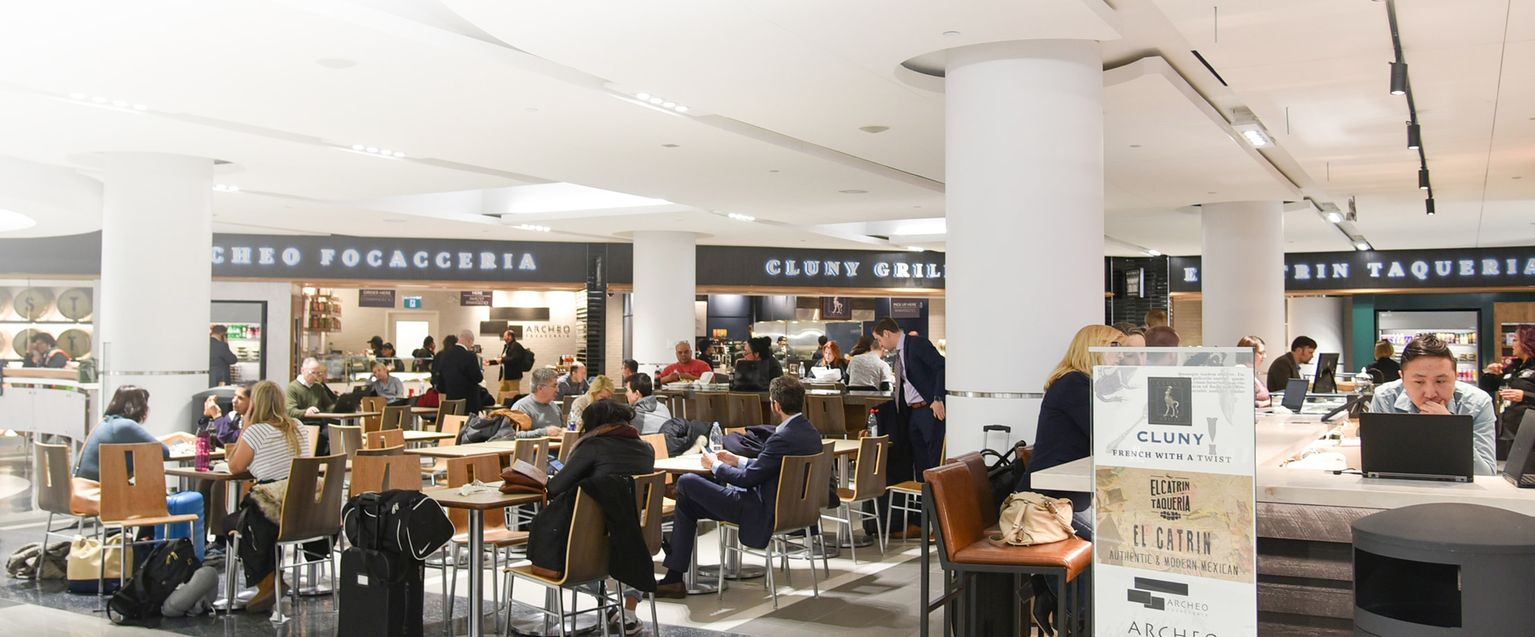 Travellers dining at an airport food court