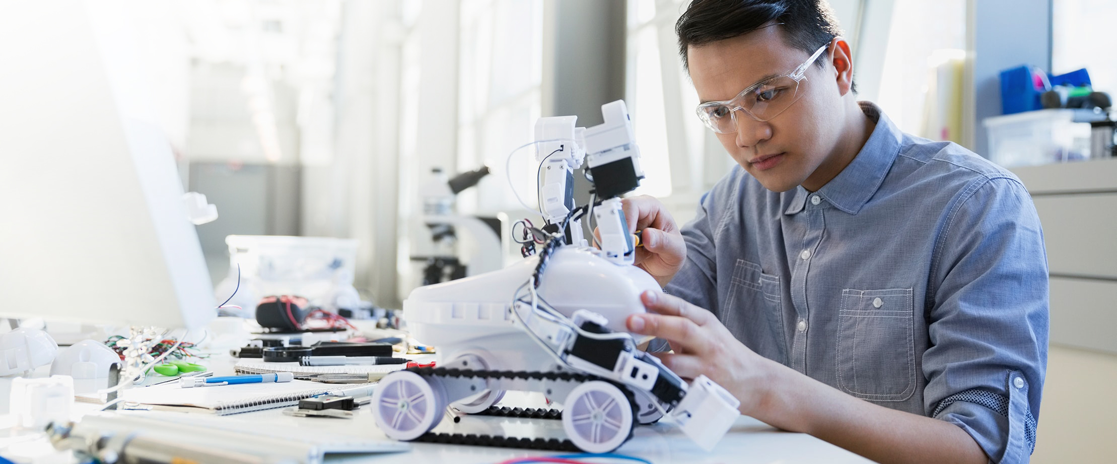 A worker focuses closely on a machine