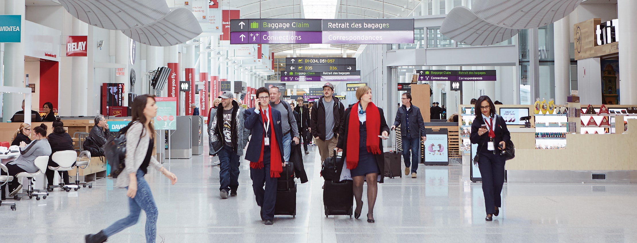 Travellers with luggage arriving at Toronto Pearson