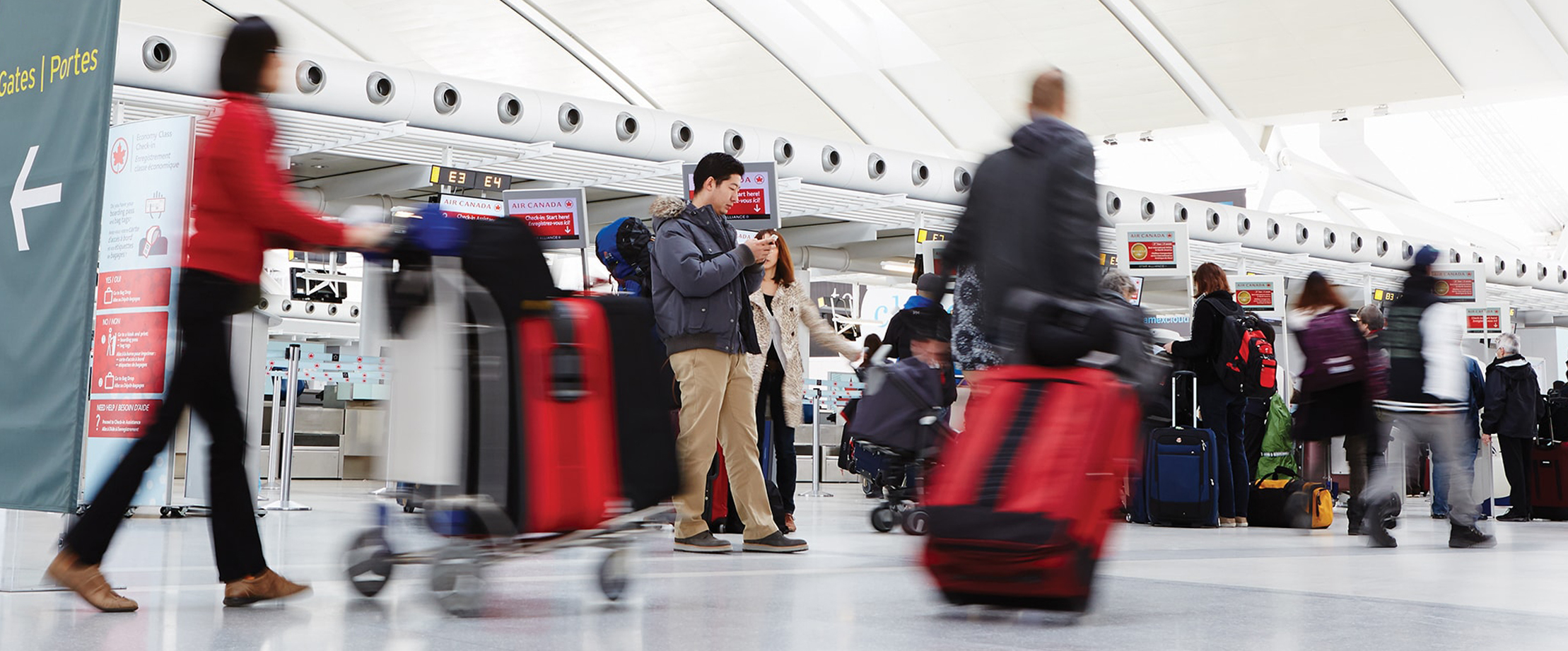 Travellers at a Toronto Pearson check-in area