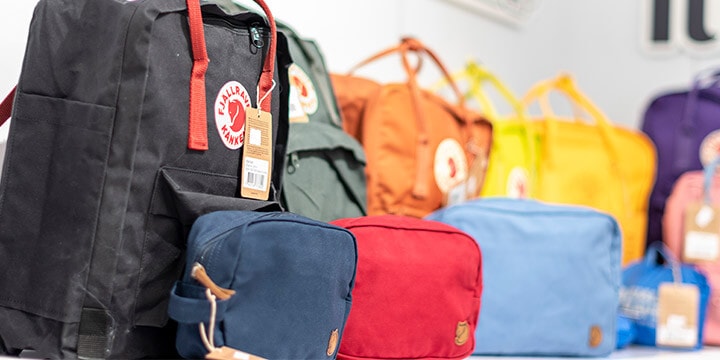 Row of colourful backpacks on display.