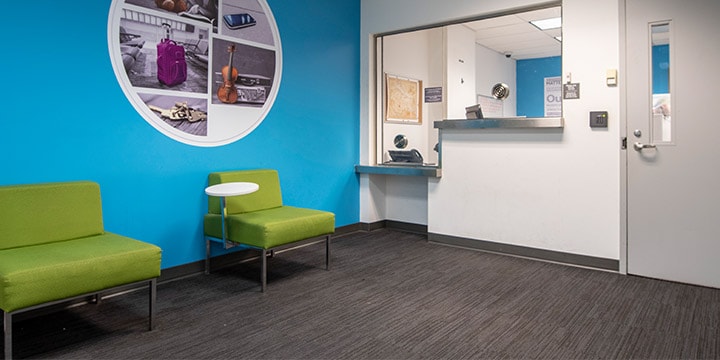 Lost and Found office with two chairs and high and low service counters.