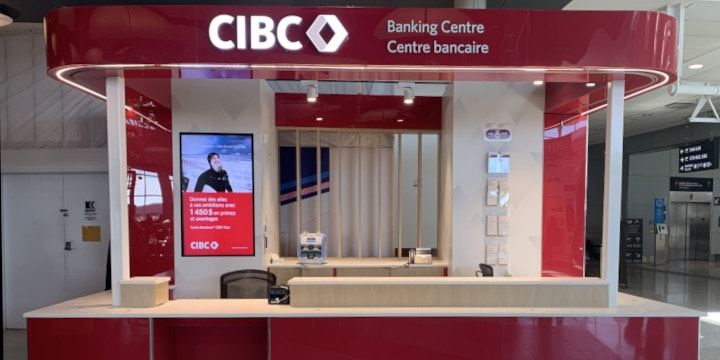 a red and white building with a sign above the door